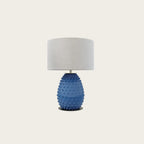 Hand-painted bobble glass table lamp with drum shade, in blue on a plain background