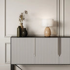 Hand-painted bobble glass table lamp with drum shade, in a warm tan on a ribbed sideboard