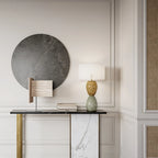 Hand-painted bobble glass table lamp with drum shade, in green on a console under a round mirror