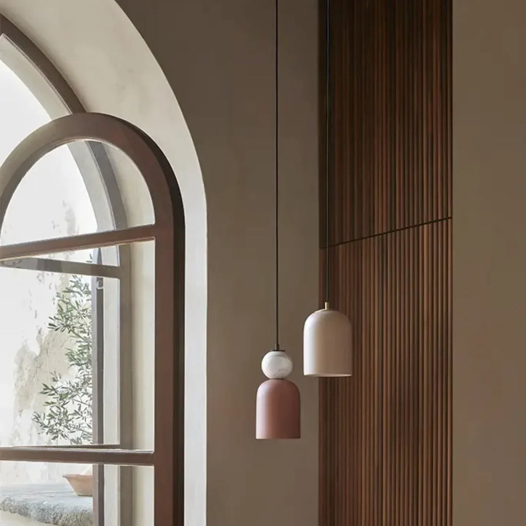 Hand-painted ceramic dome pendant, beside an arched window