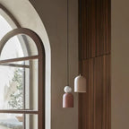 Hand-painted ceramic dome pendant, beside an arched window