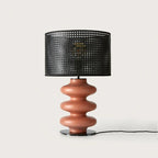 Hand-painted wavy ceramic table lamp, in terracotta with a black perforated shade