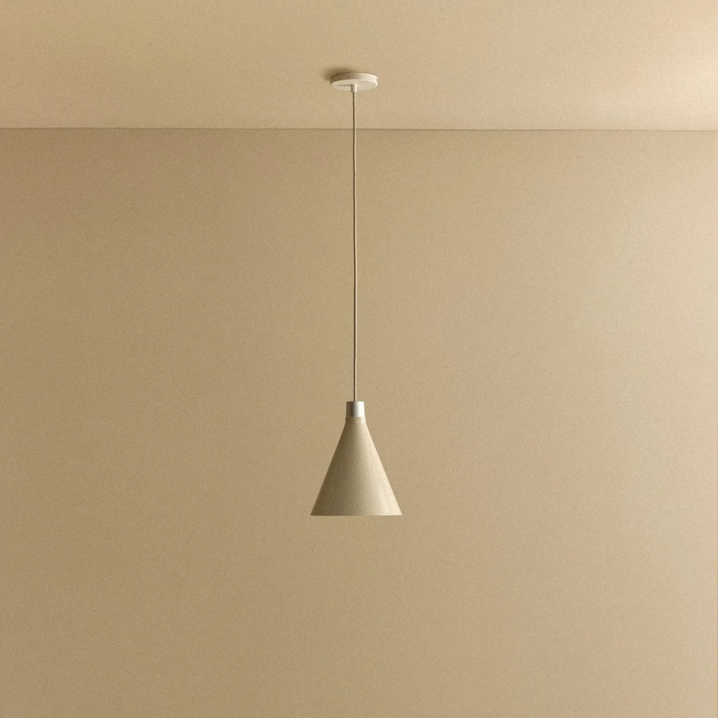 Small oyster white hand-spun steel cone pendant, against a plain wall