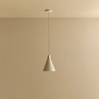 Small oyster white hand-spun steel cone pendant, against a plain wall