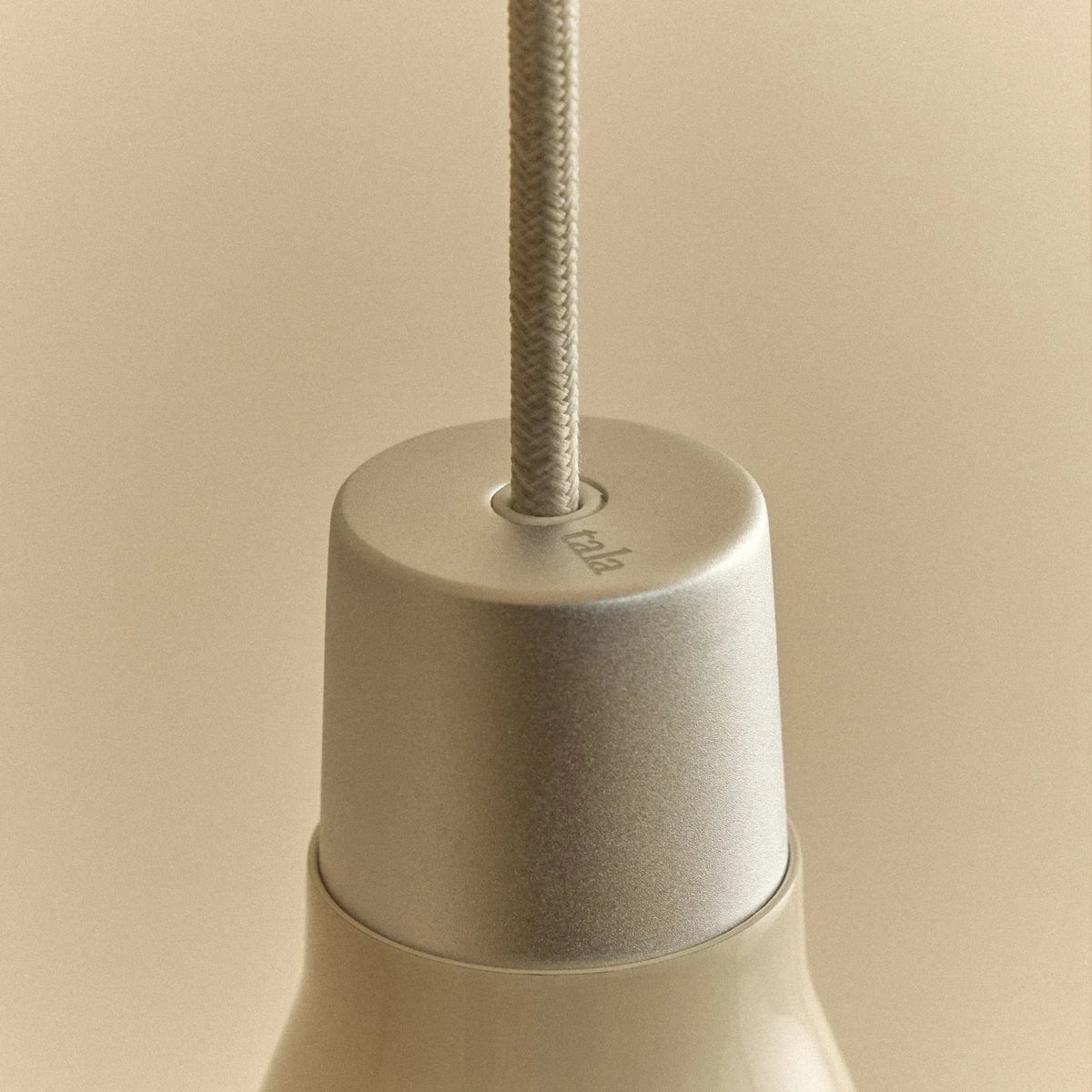 Small oyster white hand-spun steel cone pendant, close-up of the holder and cable