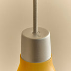 Small yellow hand-spun steel cone pendant, close-up of the holder and cable