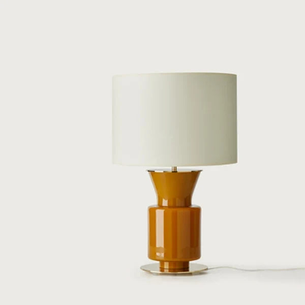 Honey glass chalice table lamp with metal disc foot, with a white drum shade (sold separately), side view