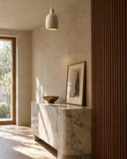 Knitted-texture pendant light, above a stone console