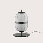 Lantern-style linen shade table lamp, black marble base, close-up of the shade and marble base