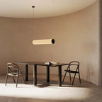 Large linen tube pendant, above a dining table in a curved room