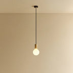 Large matte white globe pendant, oak, lit, against a plain wall