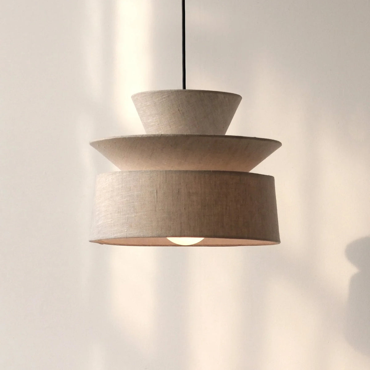 Layered cotton shade pendant, lit in soft daylight