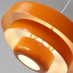 Layered metal pendant light, close-up of the orange layers