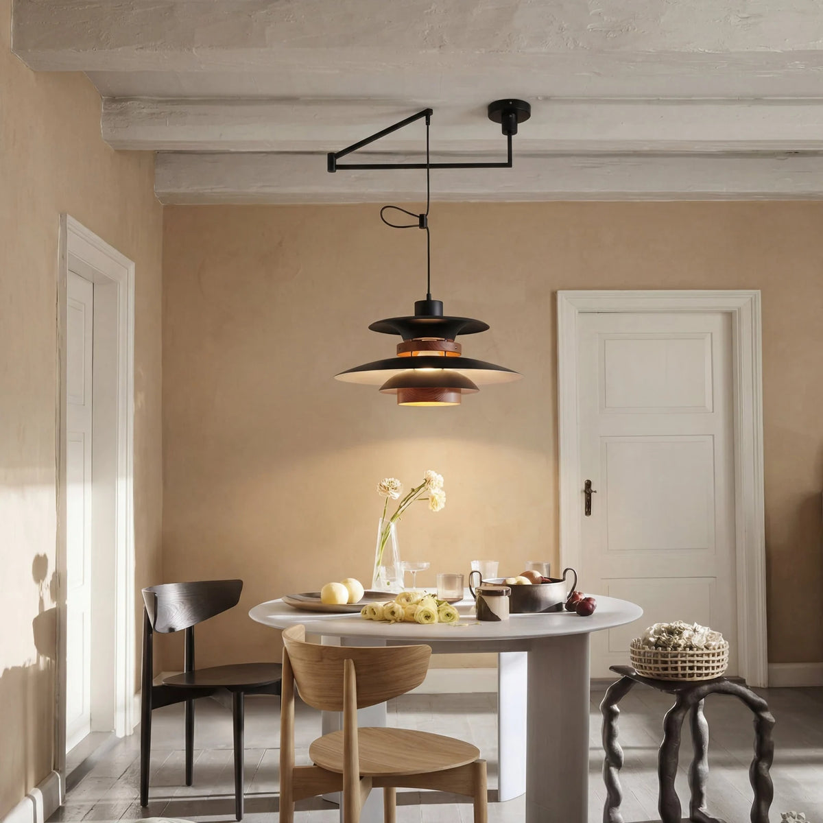 Black swing arm pendant light in a dining room