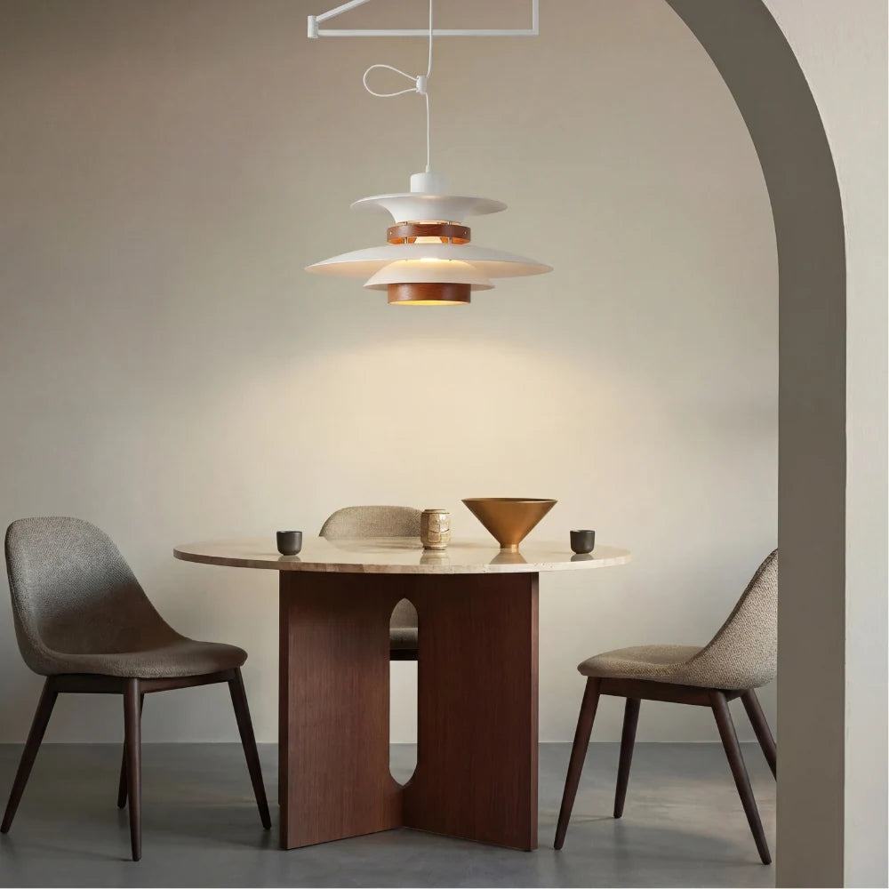 White swing arm pendant light over a round table