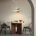 White swing arm pendant light over a round table