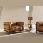 Leather drum shade table lamp, matte black base, beside a leather armchair