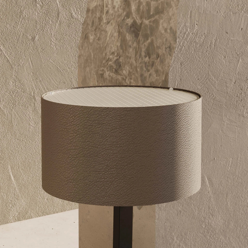 Leather drum shade table lamp, matte black base, close-up of the leather shade