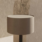 Leather drum shade table lamp, matte black base, close-up of the leather shade