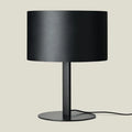 Leather drum shade table lamp, matte black base, with a black leather shade