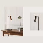 Leather-head spotlight desk lamp, marble base, with a brown leather head, beside books