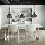 Library-style metal pendant, trio in black above a white dining table