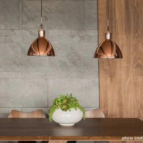 Library-style metal pendant, pair in copper above a table