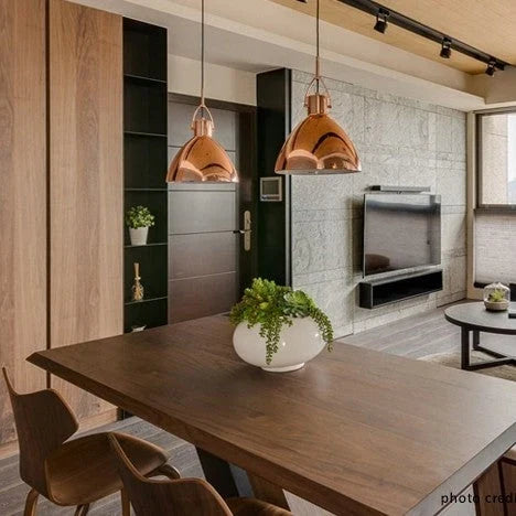 Library-style metal pendant, pair in copper above a dining table
