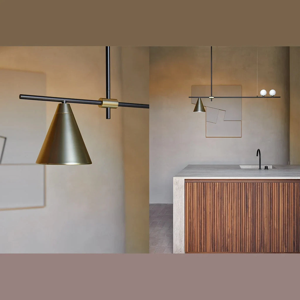 Linear bar pendant with brass cone and glass spheres, above a kitchen island