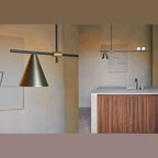 Linear bar pendant with brass cone and glass spheres, above a kitchen island