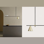 Linear bar pendant with brass cone and glass spheres, in a dining space