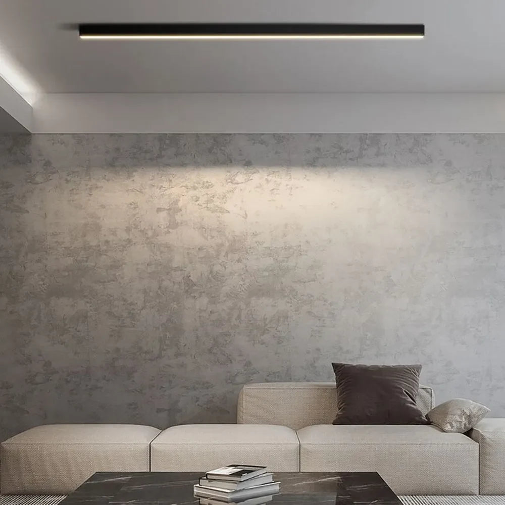 Linear black LED ceiling light, above a sofa