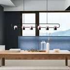 Linear frame LED pendant, in black above a long table