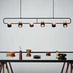 Linear frame LED pendant, in black above a table