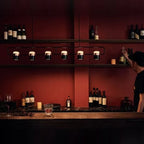 Linear frame LED pendant, in black above a bar counter