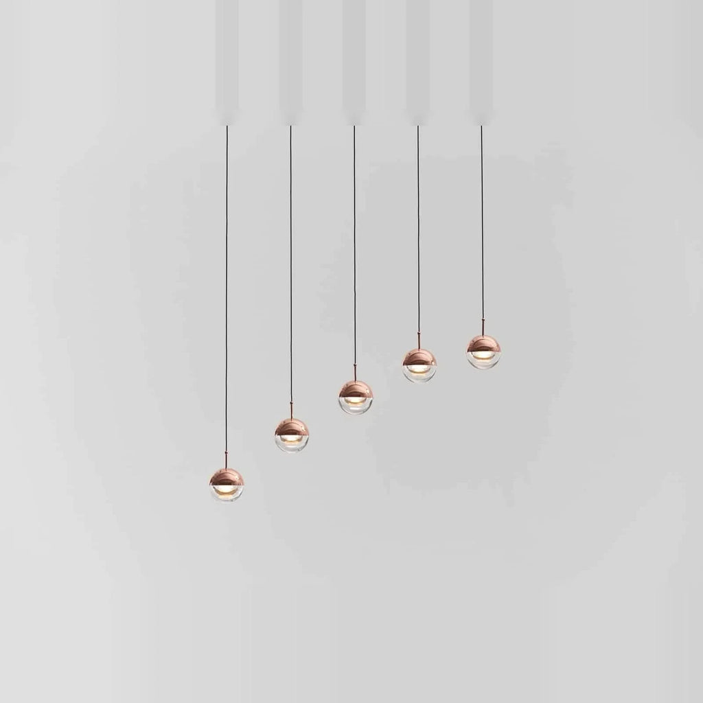 Linear glass globe pendant, five lights, in copper, stepped heights