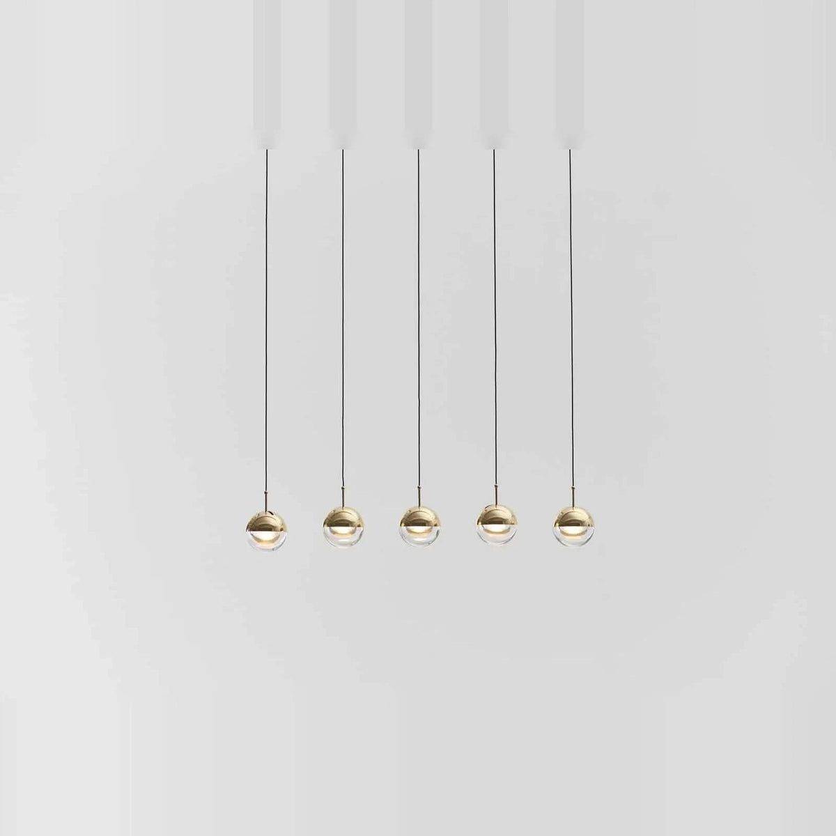 Linear glass globe pendant, five lights, in brass, in a row, low
