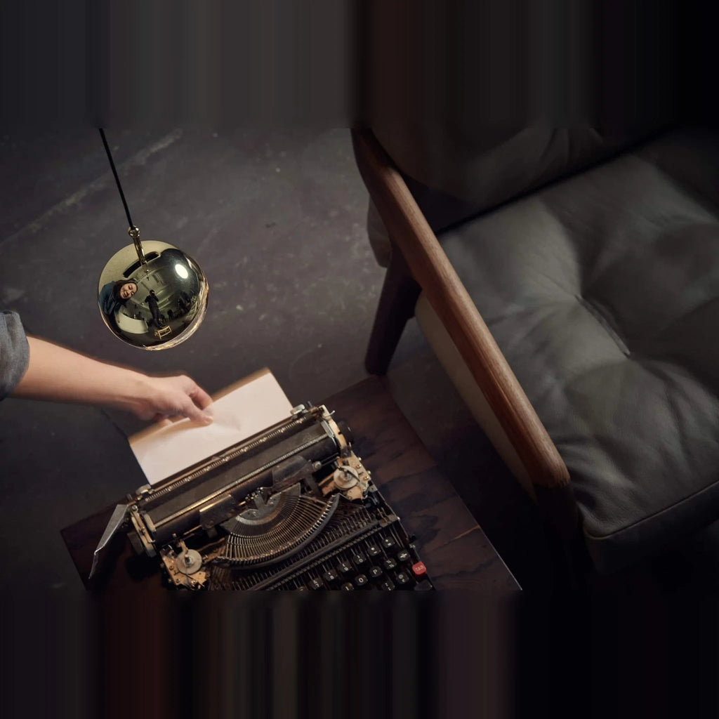 Linear glass globe pendant, five lights, single globe above a typewriter