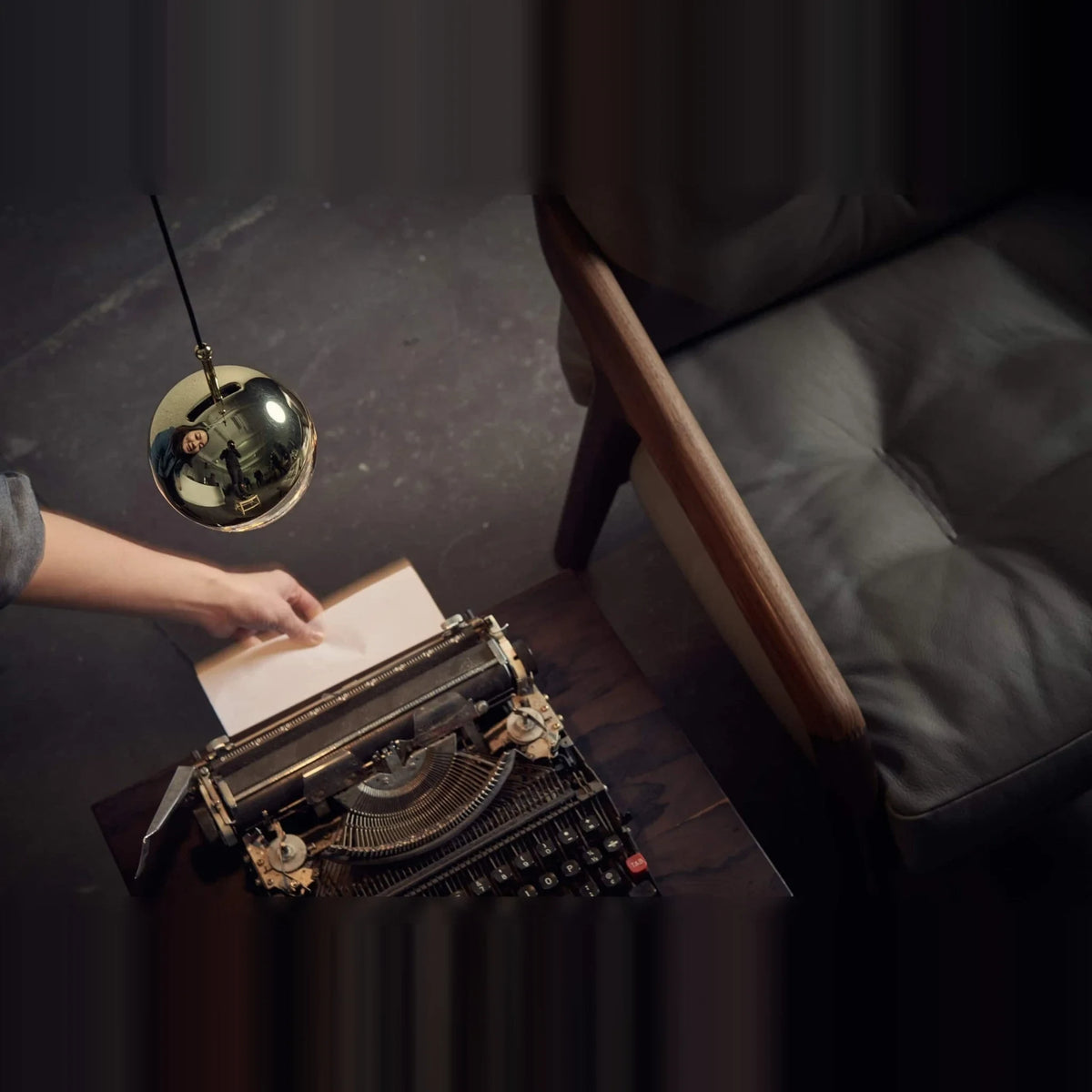 Linear glass globe pendant, five lights, single globe above a typewriter