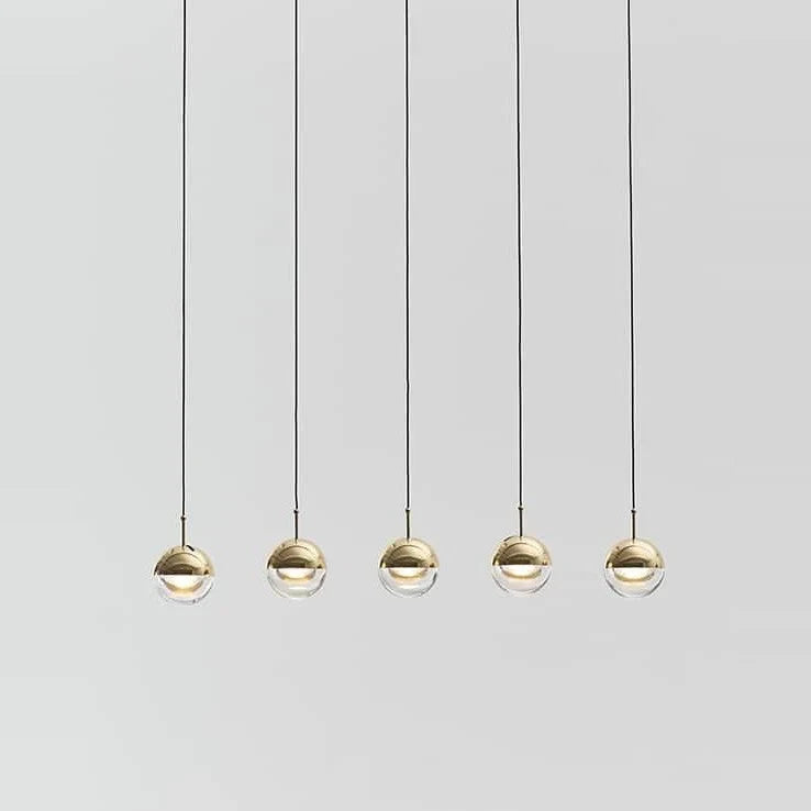 Linear glass globe pendant, five lights, in brass, in a row