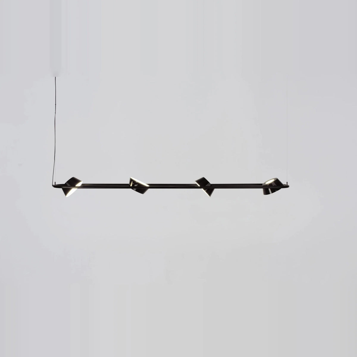 Linear LED pendant with four rotating shades, with shades turned at angles