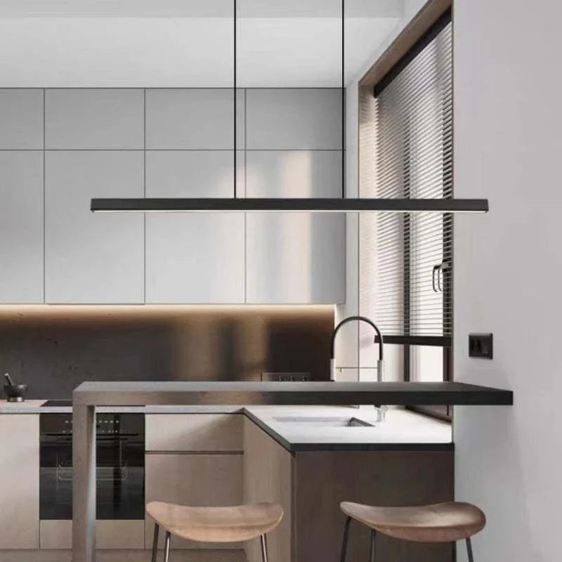 Linear LED pendant light, in black, in a modern kitchen