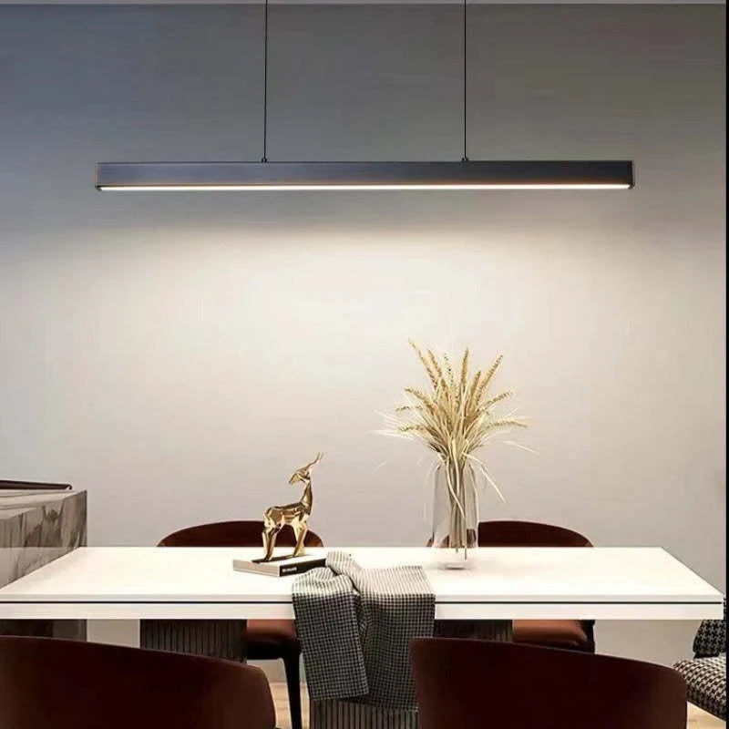 Linear LED pendant light, lit over a dining table