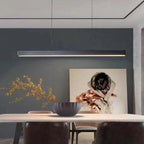 Linear LED pendant light, in black, over a dining table