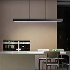 Linear LED pendant light, in black, over a kitchen island