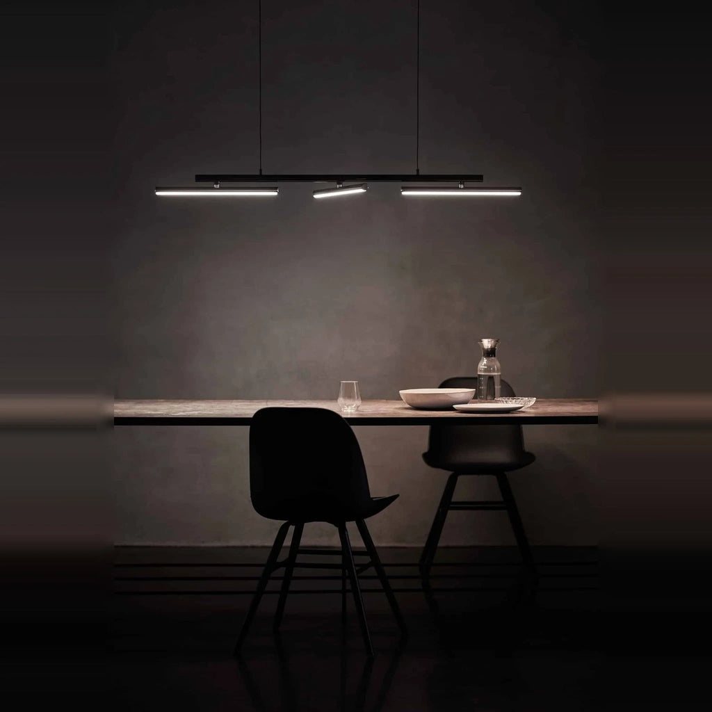 Linear LED pendant with three tilting bars, above a dining table