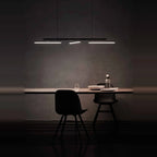 Linear LED pendant with three tilting bars, above a dining table