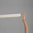 Linear LED pendant with touchless dimmer, hand at the sensor