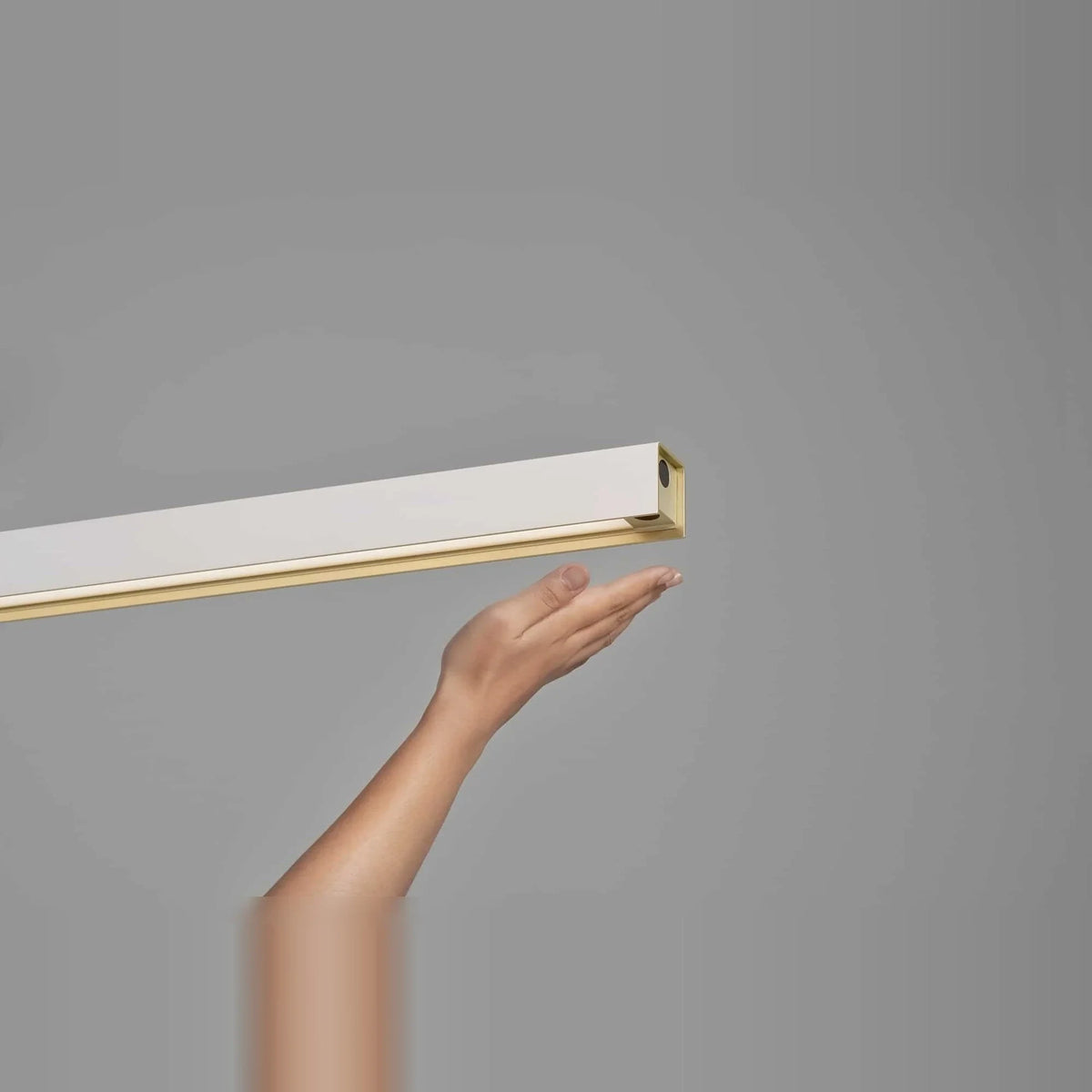 Linear LED pendant with touchless dimmer, hand under the sensor