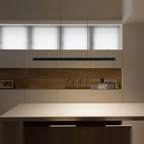 Linear LED pendant with wood ends, above a kitchen worktop